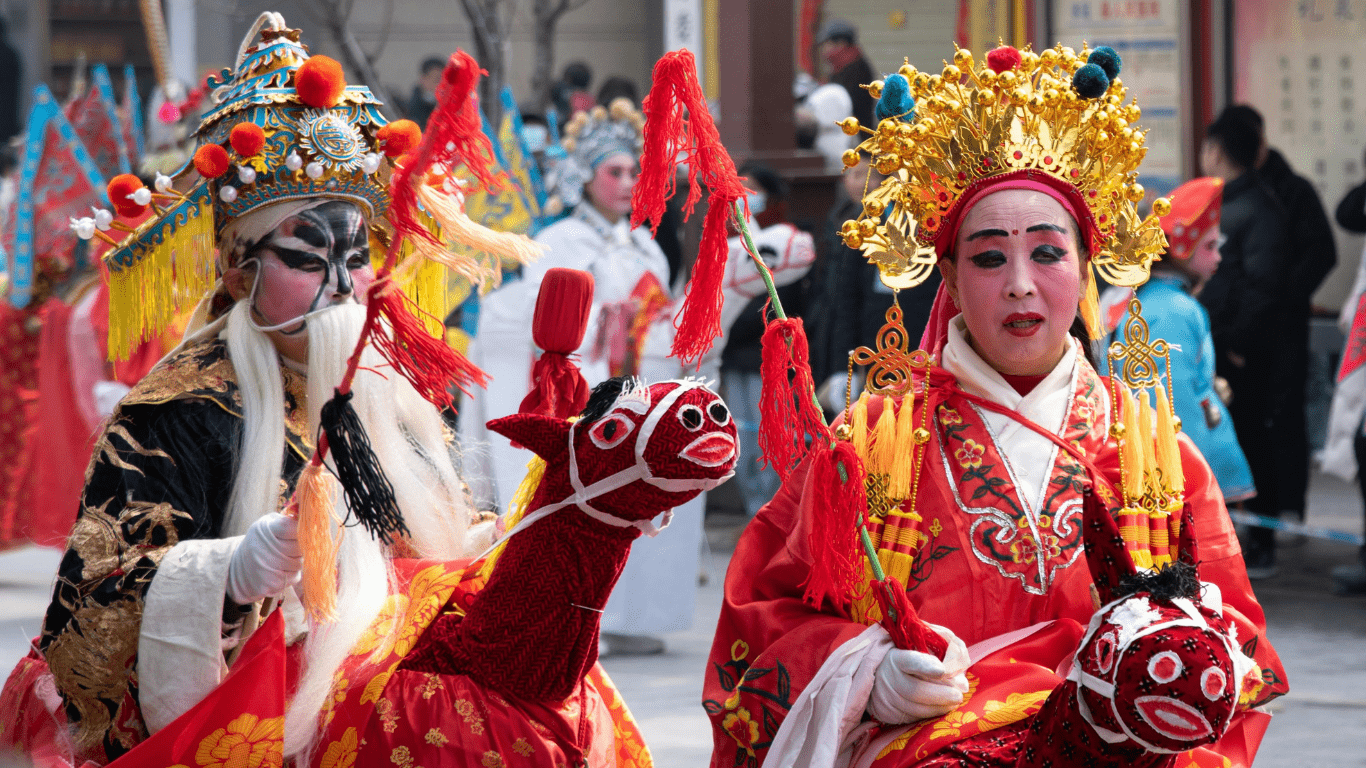 two people participating in a chinese festival