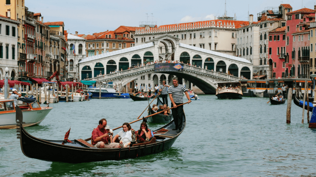 tourist riding in a boat in the grand canal